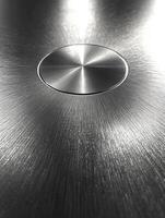 Metal surface with a button and a radial light pattern photo