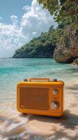 Yellow radio on sandy beach, water, island, and sky background photo