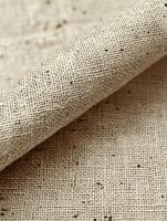 Rolled fabric with dark specks, used for textiles photo