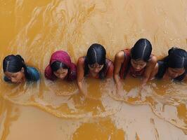 Women bathing ritually in muddy river, jungle background, documentary potential photo