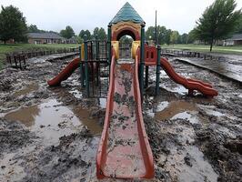 Flooded playground in residential area after heavy rain photo