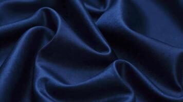 Smooth elegant blue satin fabric forming gentle curves and folds photo
