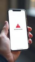 Smartphone showing error message on screen being held by person indoors photo