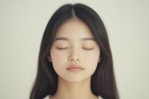 Young asian woman closing eyes and relaxing photo