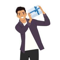 Man holds a beautifully wrapped gift box with a blue ribbon, expressing excitement and joy. vector