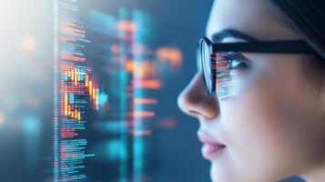 A woman in glasses examining digital interfaces with data overlaying her face banner. UX coding, big data analytics, artificial intelligence, technology, and innovation photo