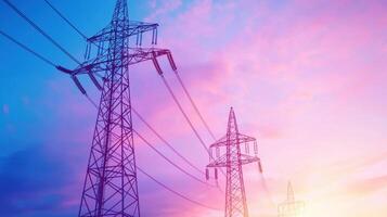 Group Electricity pylons and high voltage stand transmission power lines of silhouetted against a vibrant sunset clouds sky industrial background photo