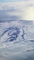 Snowy mountain range soaring through the clouds video