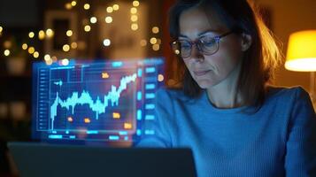 Businesswoman working late night using futuristic transparent display analyzing stock market data photo