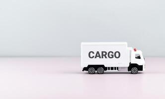 White toy truck on blocks with the text CARGO. photo