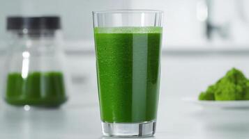 Green smoothie made with matcha powder stands on kitchen counter, promoting healthy eating and detox healthy eating copy for menu, recipe and food blog preparation space photo