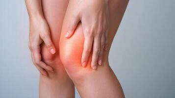 Woman grimacing, knee glowing red, signaling joint inflammation or potential damage meniscus Copy space for text photo