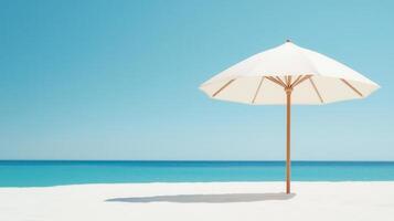 Pristine white sand beach summer featuring sunshade umbrella against turquoise water background, bright blue sky creating serene tropical vacation atmosphere Copy space for text photo