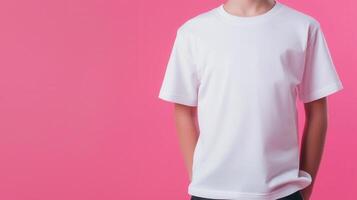 Studio portrait of a smiling child model wearing a white t shirt on a pink background, showcasing positive emotion and youthful style photo