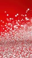 cascading glitter Silver over red glitter, forming festive, shimmering holiday background. Vertical format photo