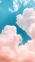 Fluffy pastel creating and cyan cumulus clouds filling a sunny sky, dreamy a pink and ethereal atmosphere. Vertical format background photo