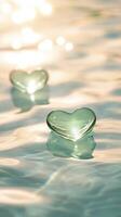 3d Glass hearts delicately floating on format water valentine love, bathed in soft golden light rippling conveying intimate. Vertical background, reflective water surface. photo