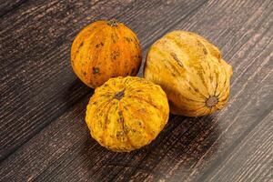 Three different types of squash on a wooden table photo