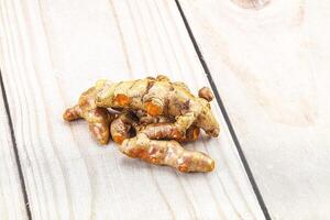 A pile of ginger on a wooden table photo