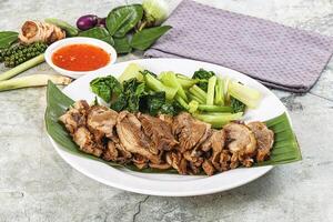 A plate with meat and vegetables on it photo
