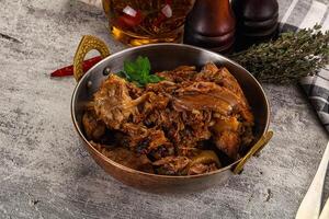 A bowl of meat and spices on a table photo