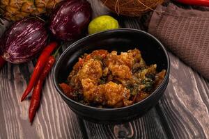 A bowl of food with vegetables and a coconut photo