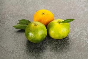 Three oranges and a lime photo