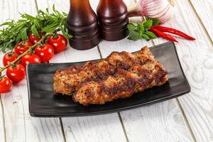 A plate with meat and vegetables on it photo