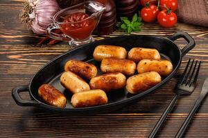 A black pan with sausage rolls on it photo
