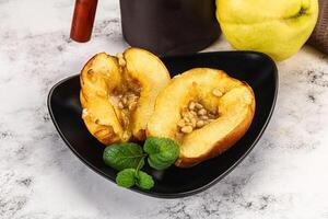 A black plate with two halves of a pear photo