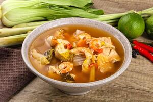 A bowl of soup with vegetables and shrimp photo