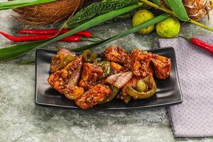 A plate of food with a coconut and some peppers photo