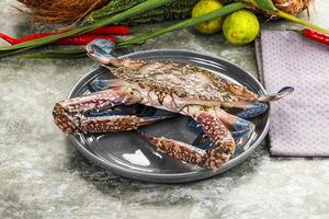 A crab on a plate with other food photo