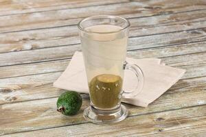 A glass of water with an avocado on a napkin photo