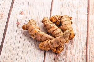 A close up of ginger root on a wooden table photo