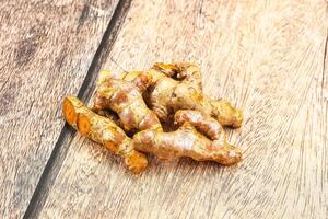 A pile of ginger on a wooden table photo