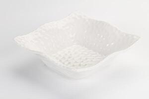 A white bowl with a patterned design on it photo