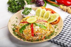 A plate of food with vegetables and a knife photo