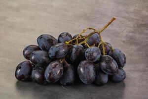 A bunch of grapes on a table photo