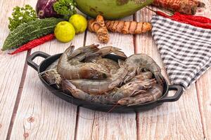 Fresh shrimp in a pan on a wooden table photo