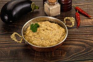 A bowl of food on a table next to a bowl of spices photo