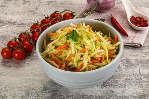 A bowl of coleslaw with carrots and tomatoes photo