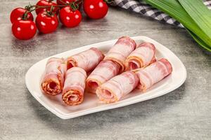 Bacon wrapped in bacon on a plate photo