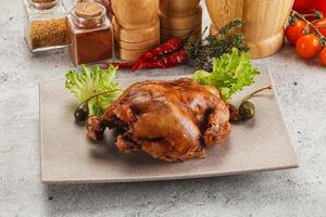 A chicken on a plate with vegetables and spices photo