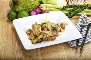 A plate of food with a fork and knife on a table photo