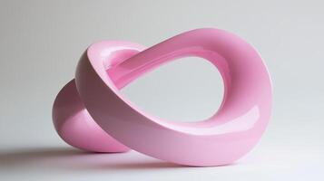 Bright pink abstract sculpture showcasing intertwined forms, emphasizing modern design and artistic expression in a minimalist setting photo