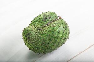 A green fruit with a white background photo