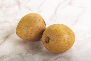 Two ripe pears on a marble surface photo