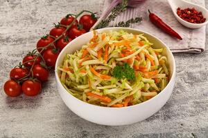 A bowl of salad with carrots and tomatoes photo