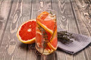 A glass of orange juice with a grapefruit slice photo